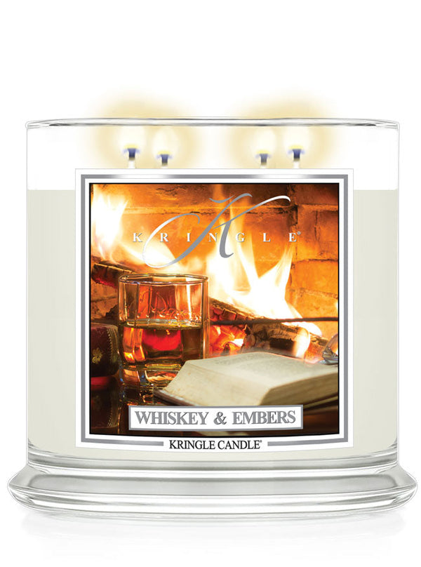 Lit Whiskey & Embers XL 4-Wick candle; label shows fireplace with a whiskey glass and an open book nearby.