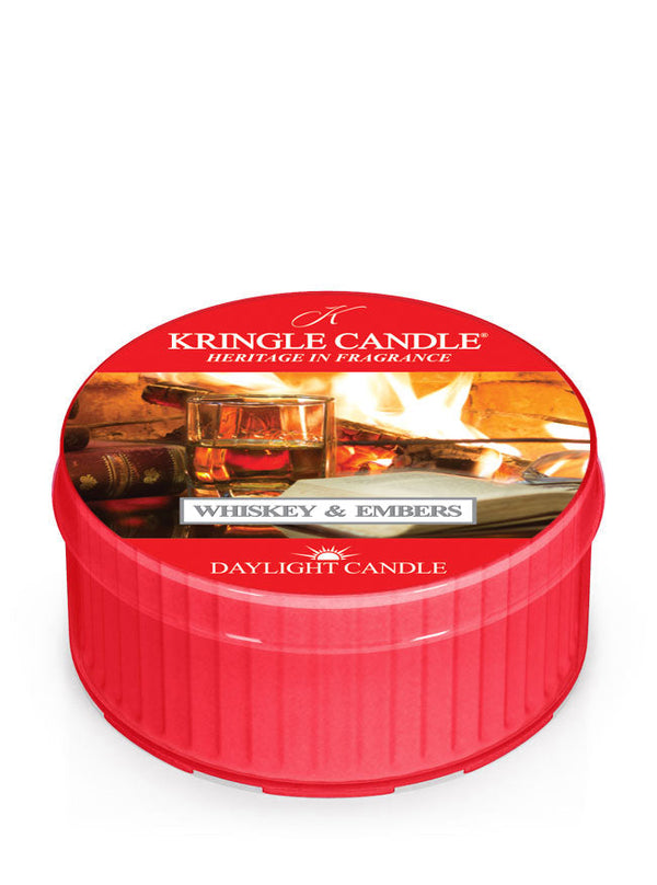 Whiskey & Embers red DayLight candle, featuring a label with whiskey glasses and a fireplace in the background.