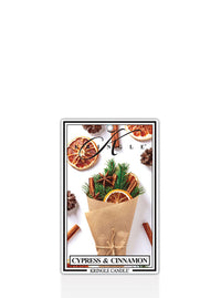 Kringle Candle Cypress and Cinnamon air freshener with cypress and cinnamon elements on a white background