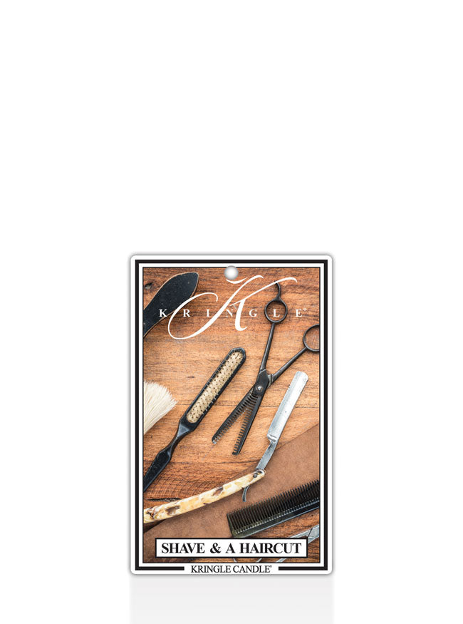 Kringle Candle air freshener with barber tools on a wooden surface label.