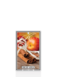 Kringle Candle Spiced Apple air freshener with apples, cinnamon sticks, and white ribbon on a white background.
