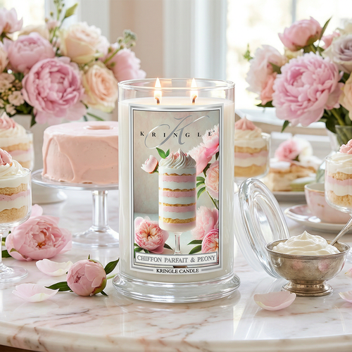 Kringle Candle with floral design on a table with desserts and flowers