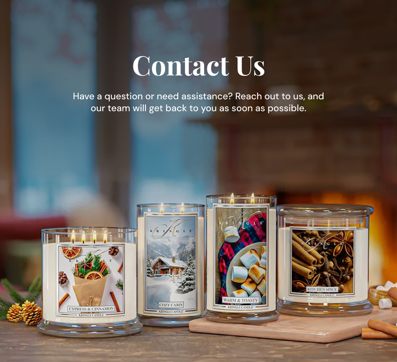 Four scented candles on a wooden surface with a blurred background