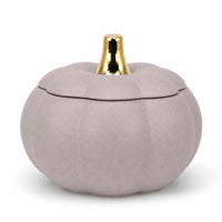 A small decorative pumpkin-shaped container with a lid, finished in a matte dusty lavender-gray color with a shiny gold stem, set against a plain white background.