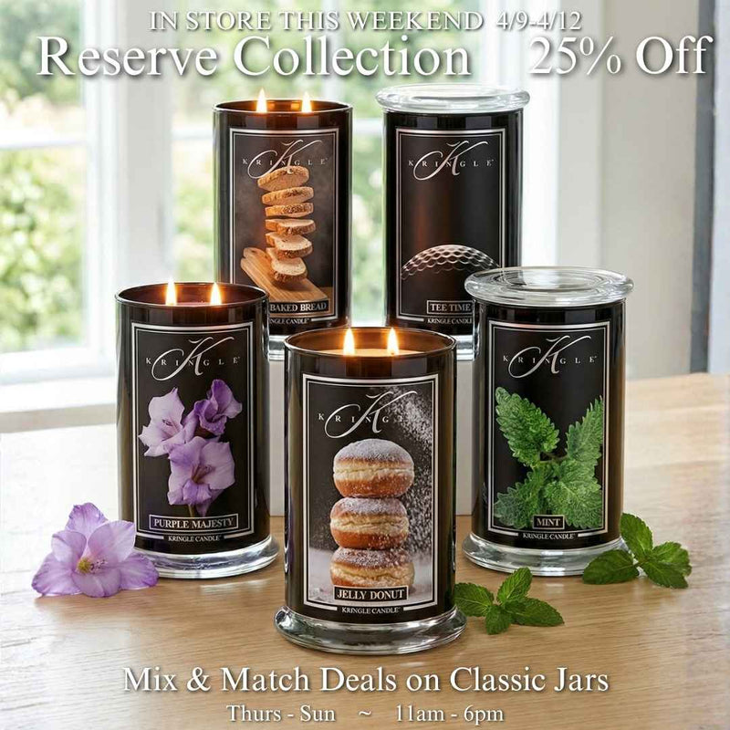 In-store promotional graphic for Kringle Candle featuring five Reserve Collection black jar candles including Baked Bread, Tee Time, Purple Majesty, Jelly Donut, and Mint arranged on a warm wood surface with fresh purple flowers and mint sprigs, announcing Reserve Collection 25% off and Mix and Match Deals on Classic Jars, in store April 9 through 12, Thursday through Sunday 11am to 6pm.