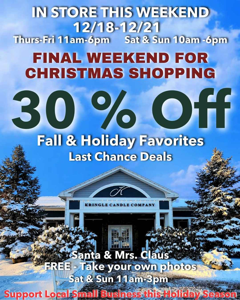 Snow-covered exterior of the Kringle Candle Company store with holiday signage announcing 30% off fall and holiday favorites, final weekend for Christmas shopping, and Santa and Mrs. Claus appearing in-store.