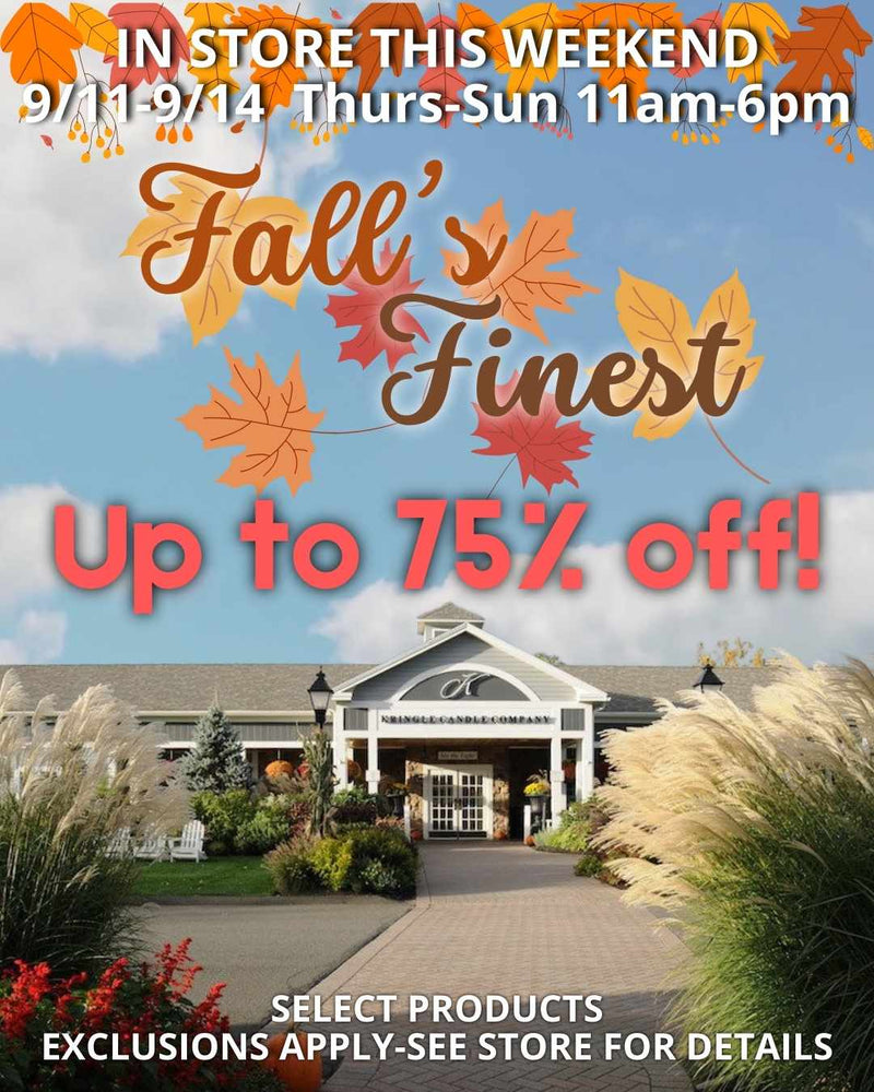 Promotional graphic for Kringle Candle’s Fall’s Finest In-Store Sale. The text reads: ‘In Store This Weekend 9/11–9/14 Thurs–Sun 11am–6pm. Fall’s Finest. Up to 75% off! Select products. Exclusions apply—see store for details.’ The background shows the Kringle Candle flagship store entrance, framed by autumn foliage, flowers, and ornamental grasses, with a clear blue sky and colorful fall leaves at the top of the design.