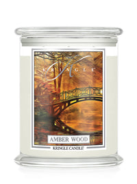 Kringle Candle in Amber Wood with a scenic label on a white background