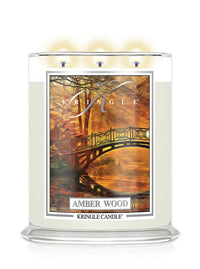 Kringle Candle in Amber Wood with a scenic label on a white background