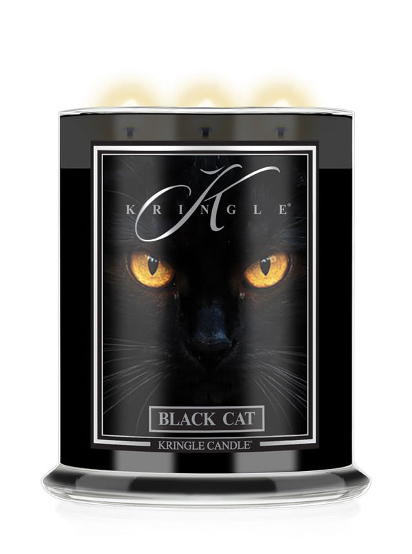 A Kringle Candle in a black Halloween jar featuring a graphic label of a black cat's face with glowing yellow eyes and the text 'BLACK CAT'.