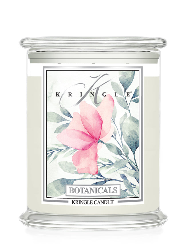 A Kringle Candle in a clear glass jar with a white wax fill and a decorative botanical label featuring a pink flower and green leaves.