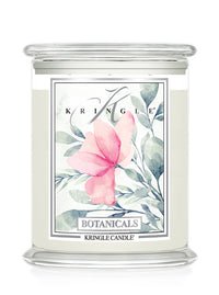 A Kringle Candle in a clear glass jar with a white wax fill and a decorative botanical label featuring a pink flower and green leaves.