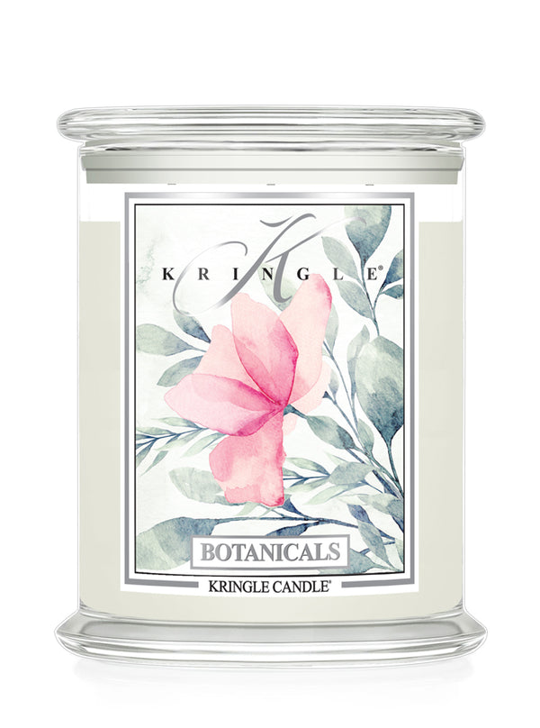 A Kringle Candle in a clear glass jar with a white wax fill and a decorative botanical label featuring a pink flower and green leaves.