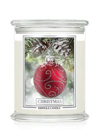 A Kringle Candle jar candle with a festive Christmas design. The candle features a clear glass jar filled with off-white wax, topped with a clear glass lid.