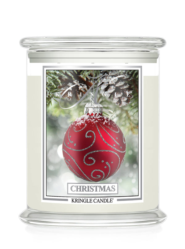 A Kringle Candle jar candle with a festive Christmas design. The candle features a clear glass jar filled with off-white wax, topped with a clear glass lid.