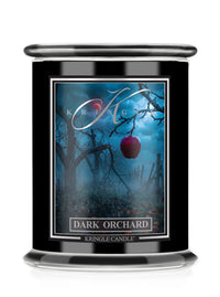Kringle Candle's Halloween Dark Orchard Candle with an apple and leafless trees.