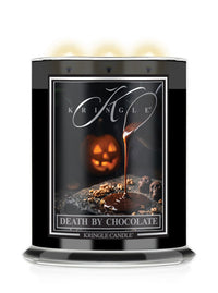 A Kringle Candle in a tall black glass jar with three lit wicks, featuring a Halloween-themed label that reads 'Death by Chocolate' with a chocolate-dripping jack-o'-lantern design.