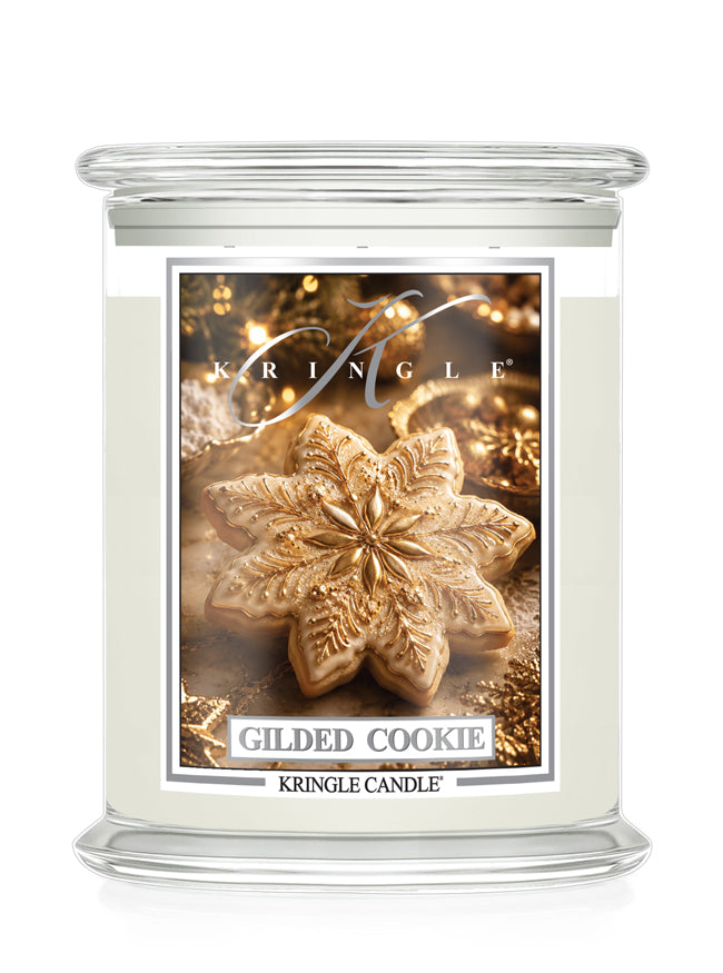 A Kringle Candle in a clear glass jar with a white wax fill and a decorative front label featuring a gilded cookie design and the scent name 'Gilded Cookie'.