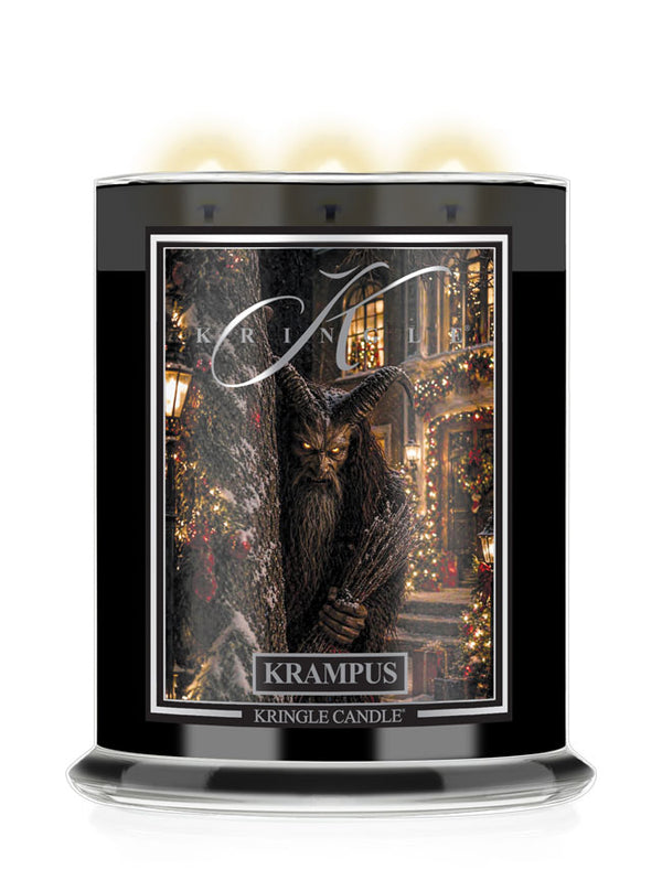 A Kringle Candle Halloween jar labeled 'Krampus', a festive holiday illustration of a horned beast in the center, and three glowing candles visible at the top on a white background.