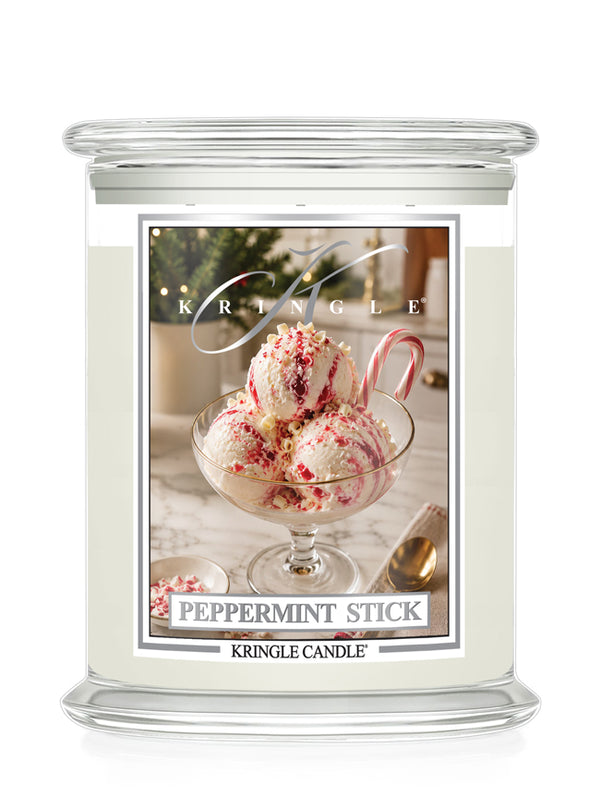 A Kringle Candle jar candle labeled 'Peppermint Stick' with a clear glass jar, cream-colored wax, and a front label showing a dessert photo and the Kringle brand name.