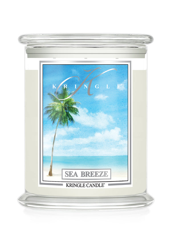 Kringle Candle with 'Sea Breeze' label featuring a palm tree and beach scene on a white background