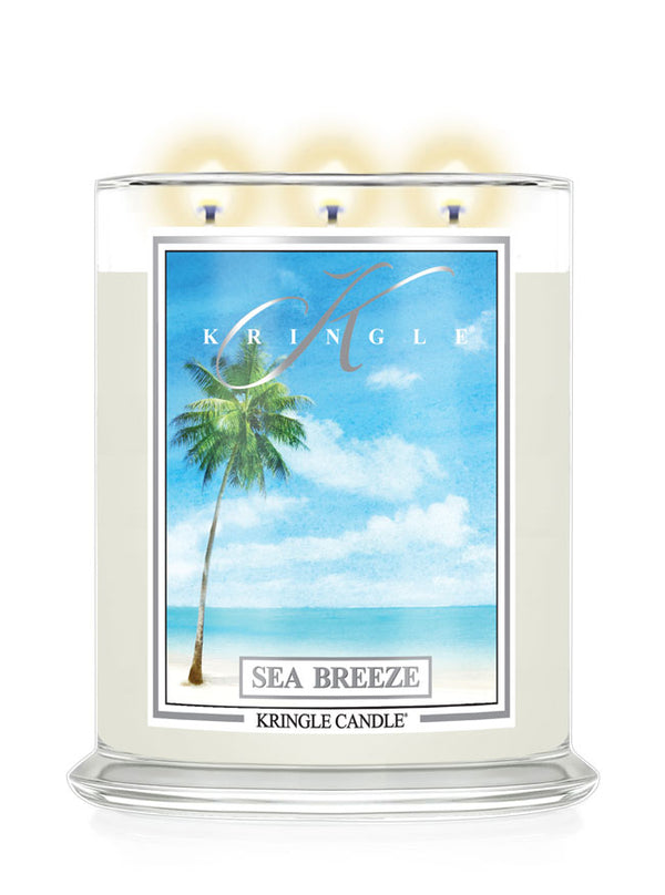 Kringle Candle with 'Sea Breeze' label featuring a palm tree and beach scene on a white background
