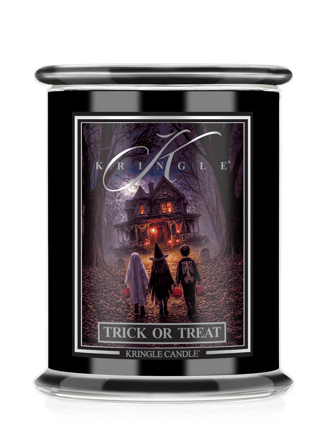 A black glass jar candle featuring a Halloween-themed label that reads 'Kringle' and 'Trick or Treat'. The label depicts three children standing in front of a haunted house in a dark, spooky forest.