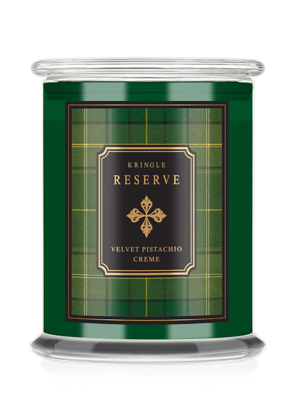 A Kringle Reserve candle in a clear glass jar with a green label featuring a tartan plaid pattern and a black central label with gold lettering.