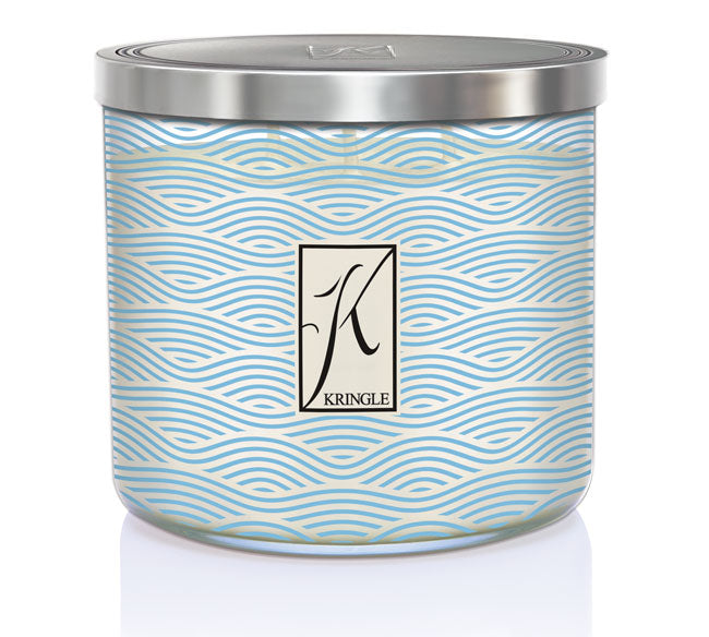 Sea Salt & Tonka 3-wick candle in a jar with blue wavy linel patterns and a silver lid. Central logo reads 