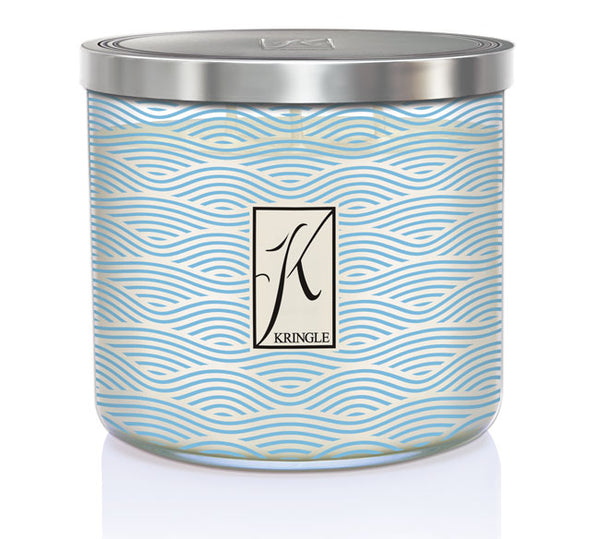 Sea Salt & Tonka 3-wick candle in a jar with blue wavy linel patterns and a silver lid. Central logo reads "Kringle."