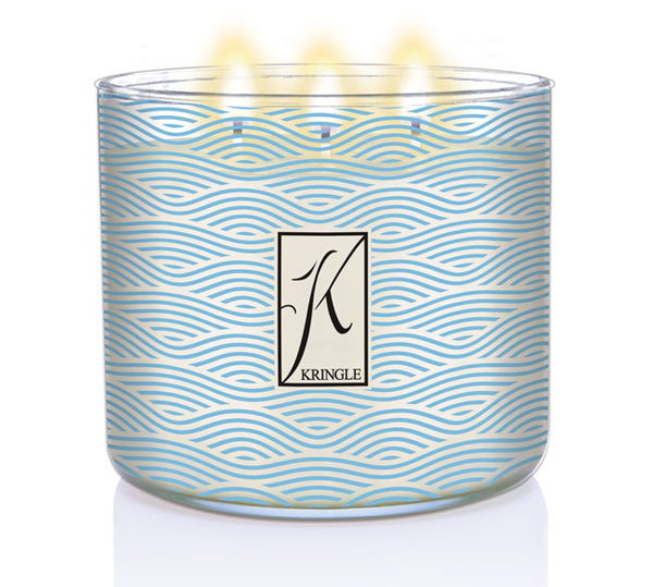 Sea Salt & Tonka 3-wick lit candle in a jar with blue wavy linel patterns and a silver lid. Central logo reads "Kringle."