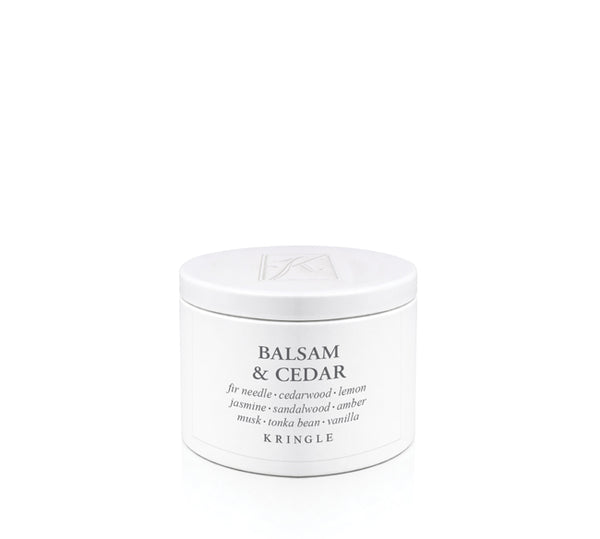A white cylindrical jar of Kringle Balsam & Cedar candle scent with black text, centered on a clean white background.