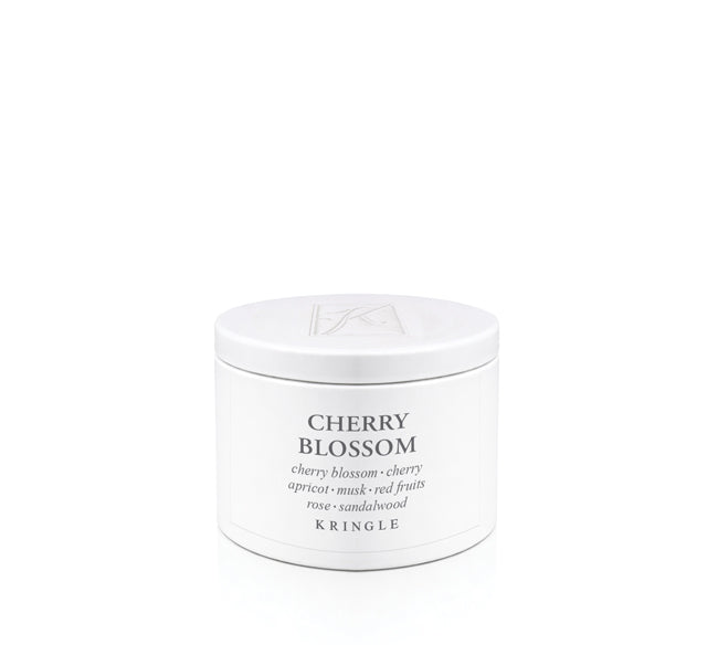 A white cylindrical tin of Kringle Cherry Blossom candle wax with black text on a clean white background.
