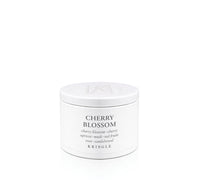 A white cylindrical tin of Kringle Cherry Blossom candle wax with black text on a clean white background.