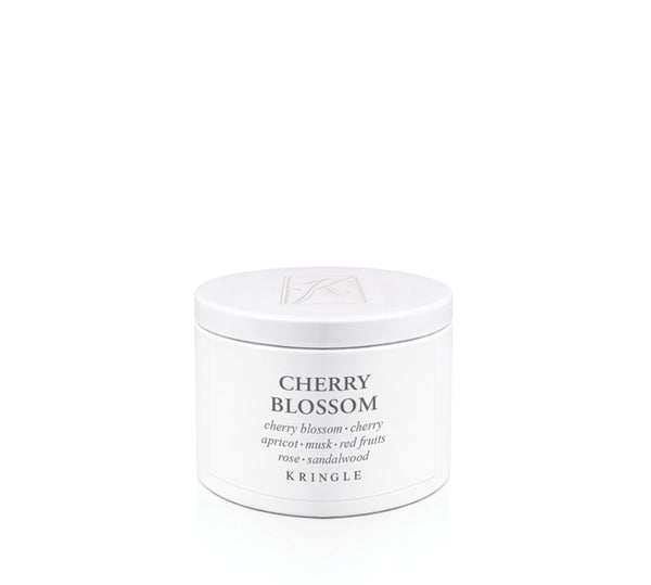 A white cylindrical tin of Kringle Cherry Blossom candle wax with black text on a clean white background.