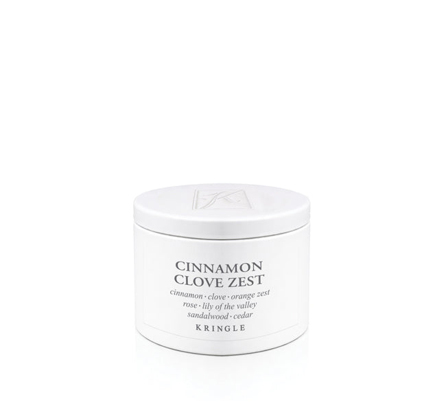 A white round cosmetic jar labeled 'CINNAMON CLOVE ZEST' by Kringle, photographed on a clean white background.