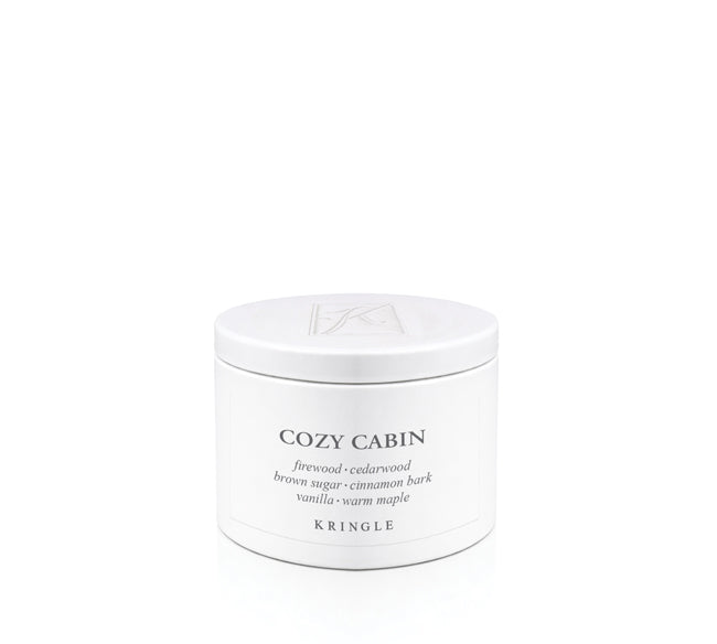 A white cylindrical metal candle tin of Kringle Cozy Cabin scented candle wax with black text on a clean white background.