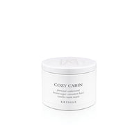 A white cylindrical metal candle tin of Kringle Cozy Cabin scented candle wax with black text on a clean white background.