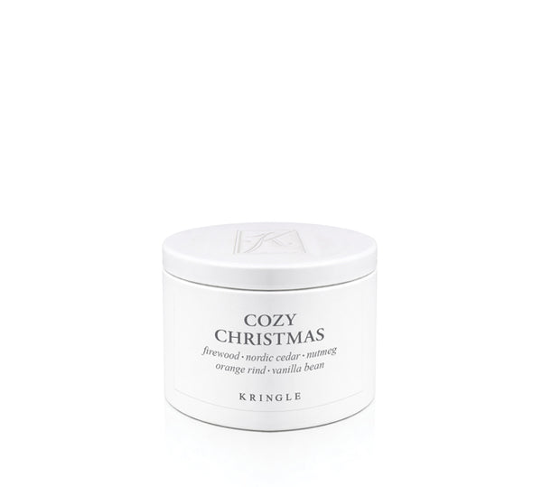 A white cylindrical metal tin of Kringle Cozy Christmas candle with black text on a clean white background.