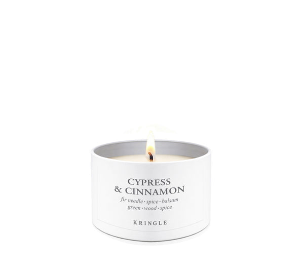 Cypress & Cinnamon Scent in mini candle tin lit single-wick on a white background by Kringle Candle