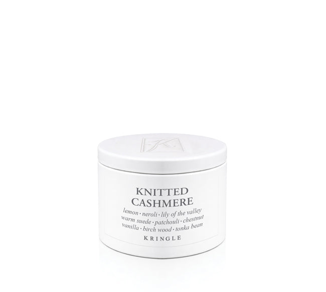 A white cylindrical candle tin of Kringle 'Knitted Cashmere' scented product on a seamless white background.