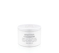 A white cylindrical candle tin of Kringle 'Knitted Cashmere' scented product on a seamless white background.