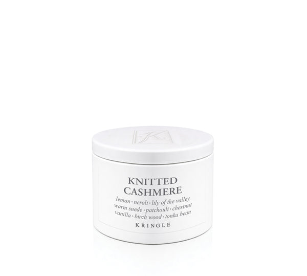 A white cylindrical candle tin of Kringle 'Knitted Cashmere' scented product on a seamless white background.