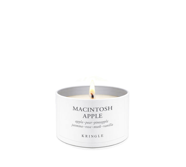 White candle in a tin container labeled 'Amber Wood' by Kringle on a white background
