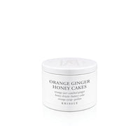 Kringle Candle jar labeled 'Orange Ginger Honey Cakes' on a white background