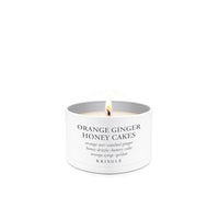 Candle labeled 'Orange Ginger Honey Cakes' by Kringle on a white background