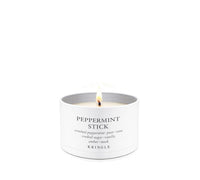 A lit Kringle Peppermint Stick candle in a white cylindrical tin with a single flame visible, centered on a clean white background.