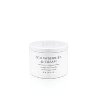 Kringle Candle 'Strawberries & Cream' scent in a tin container on a white background