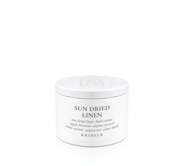 Kringle Candle tin labeled 'Sun Dried Linen' on a white background