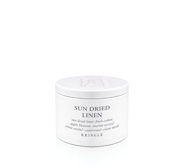 Kringle Candle tin labeled 'Sun Dried Linen' on a white background
